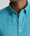 Model is wearing UNTUCKit Halloway shirt in teal. 