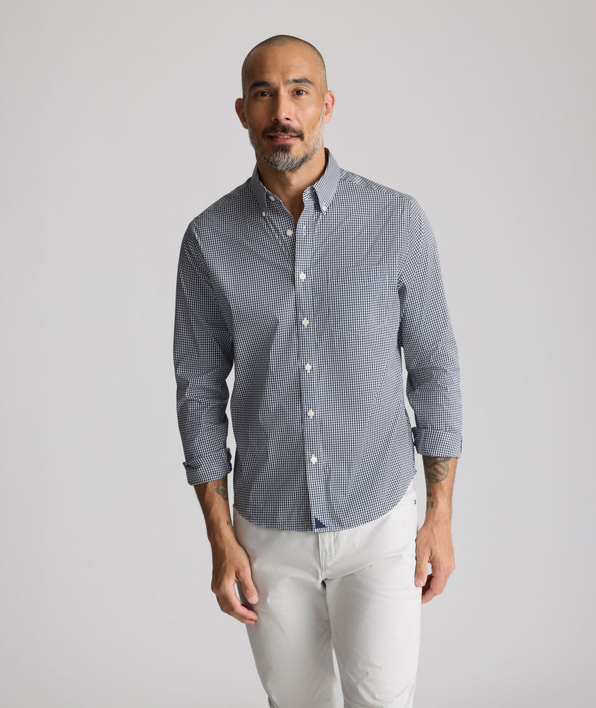 Model is wearing UNTUCKit CottonTek Harland Shirt in navy. 