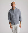 Model is wearing UNTUCKit CottonTek Harland Shirt in navy. 