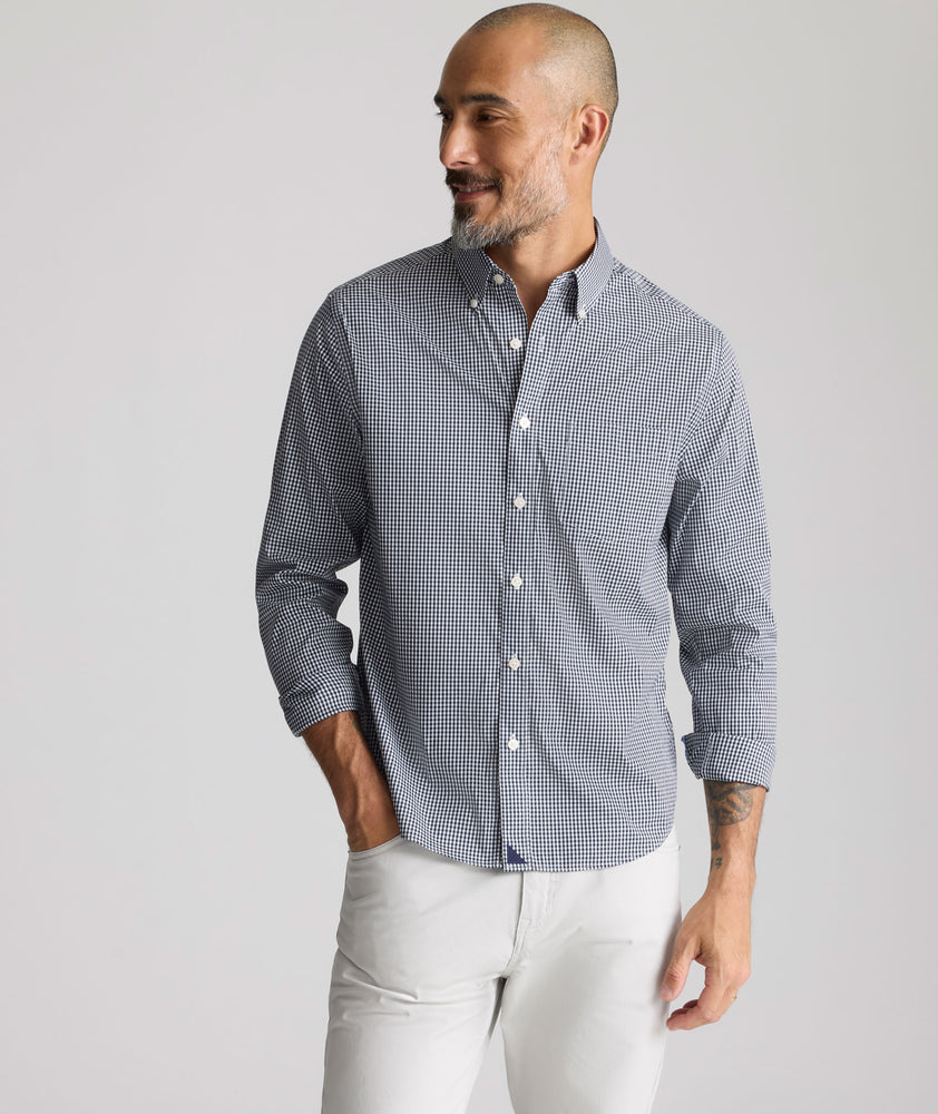 Model is wearing UNTUCKit CottonTek Harland Shirt in navy. 