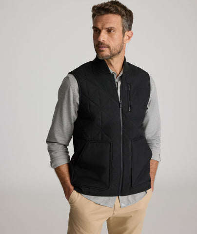 Model is wearing UNTUCKit Harper vest in black. 