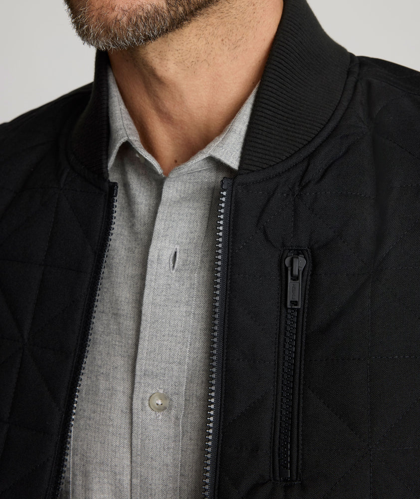 Model is wearing UNTUCKit Harper vest in black. 