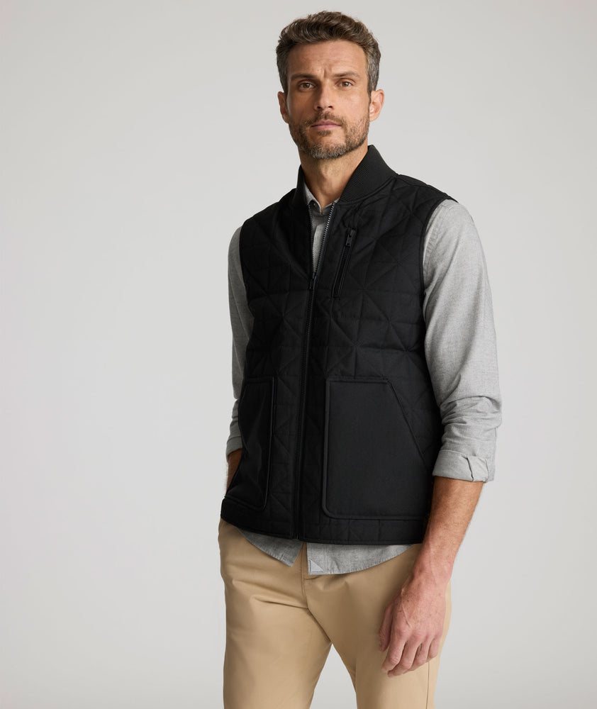 Model is wearing UNTUCKit Harper vest in black. 