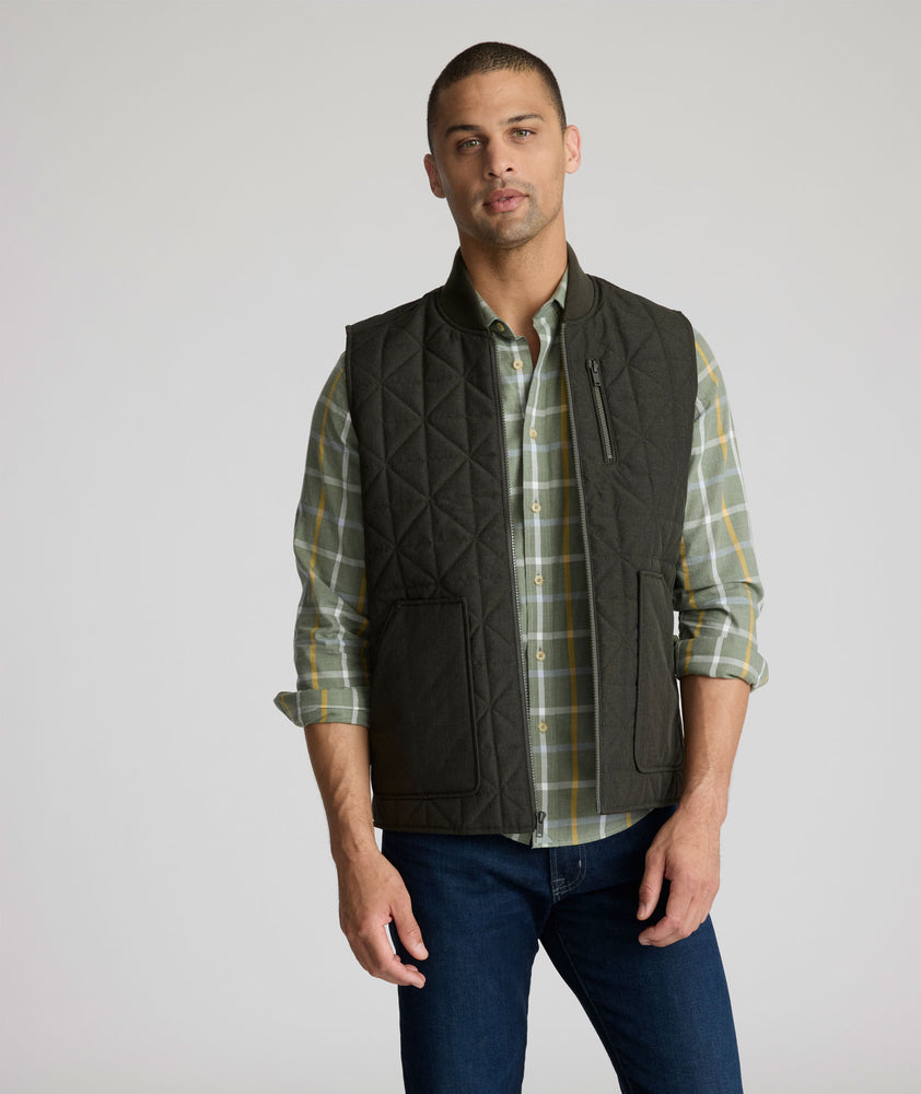 Model is wearing UNTUCKit Harper vest in dark gray/green.