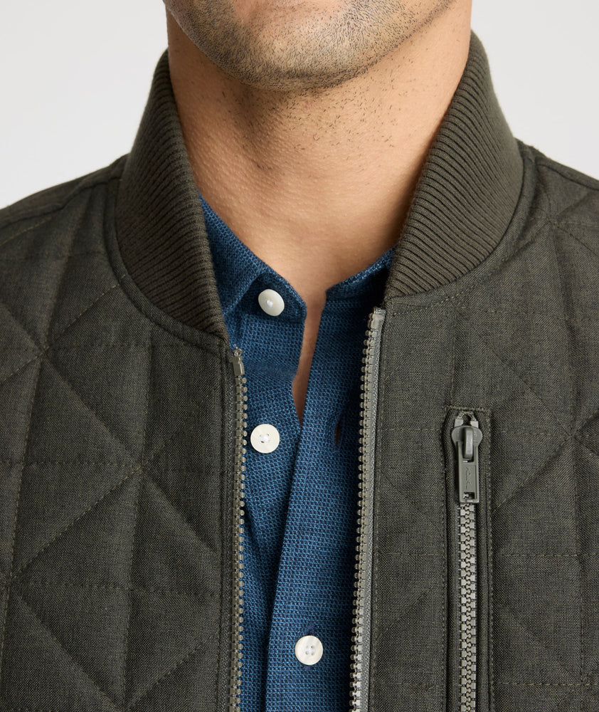 Model is wearing UNTUCKit Harper vest in dark gray/green.