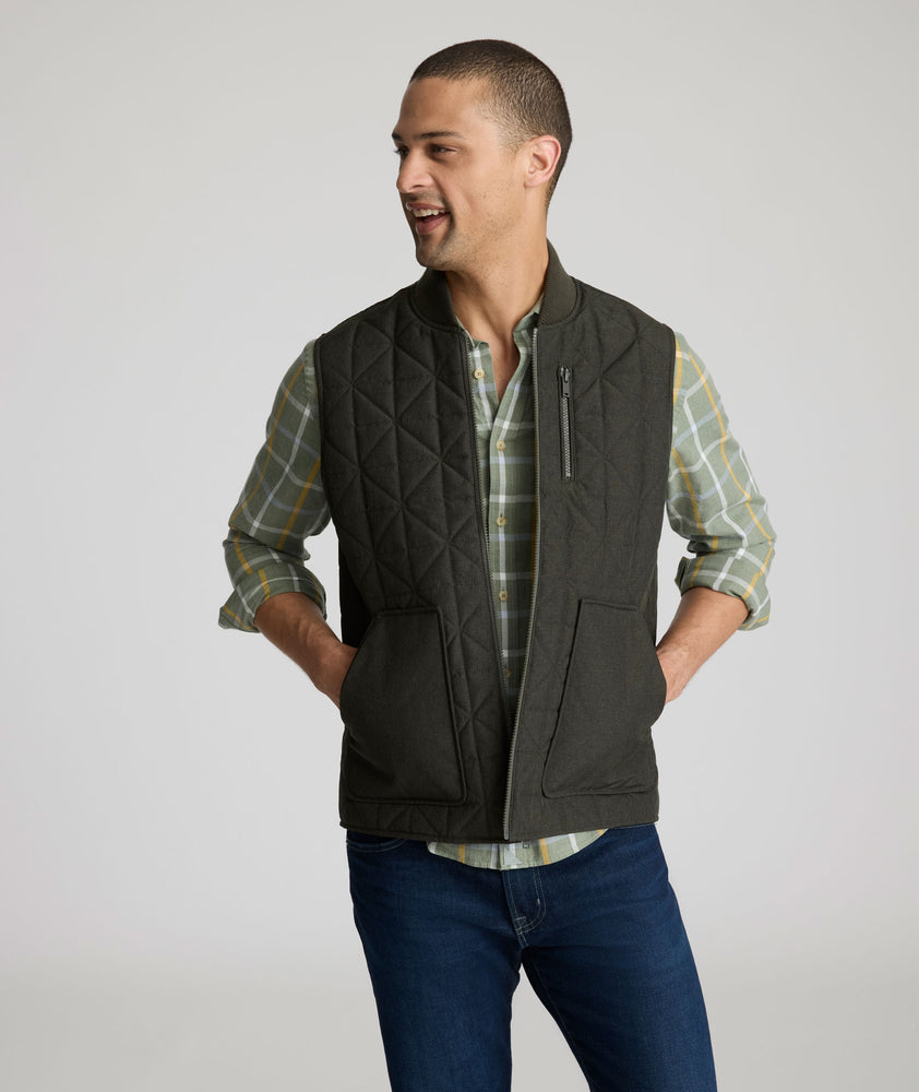Model is wearing UNTUCKit Harper vest in dark gray/green.