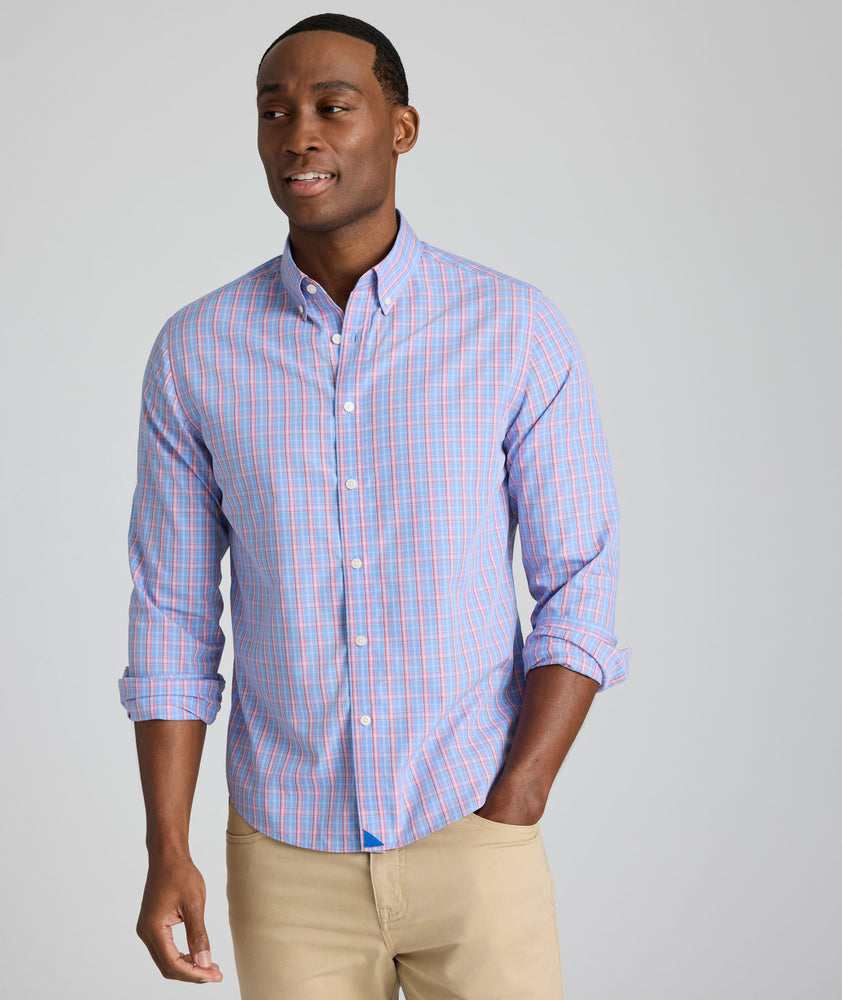 Model is wearing UNTUCKit Harrington wrinkle-free plaid blue shirt. 
