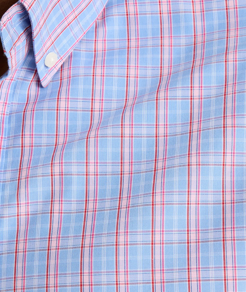 Model is wearing UNTUCKit Harrington wrinkle-free plaid blue shirt. 