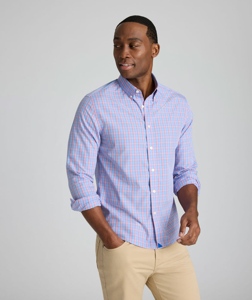 Model is wearing UNTUCKit Harrington wrinkle-free plaid blue shirt. 