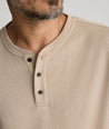Model is wearing UNTUCKit Harrow henley in cobblestone. 