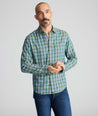 Model is wearing UNTUCKit Ultrasoft Flannel Shirt in Green & Brown Plaid. 