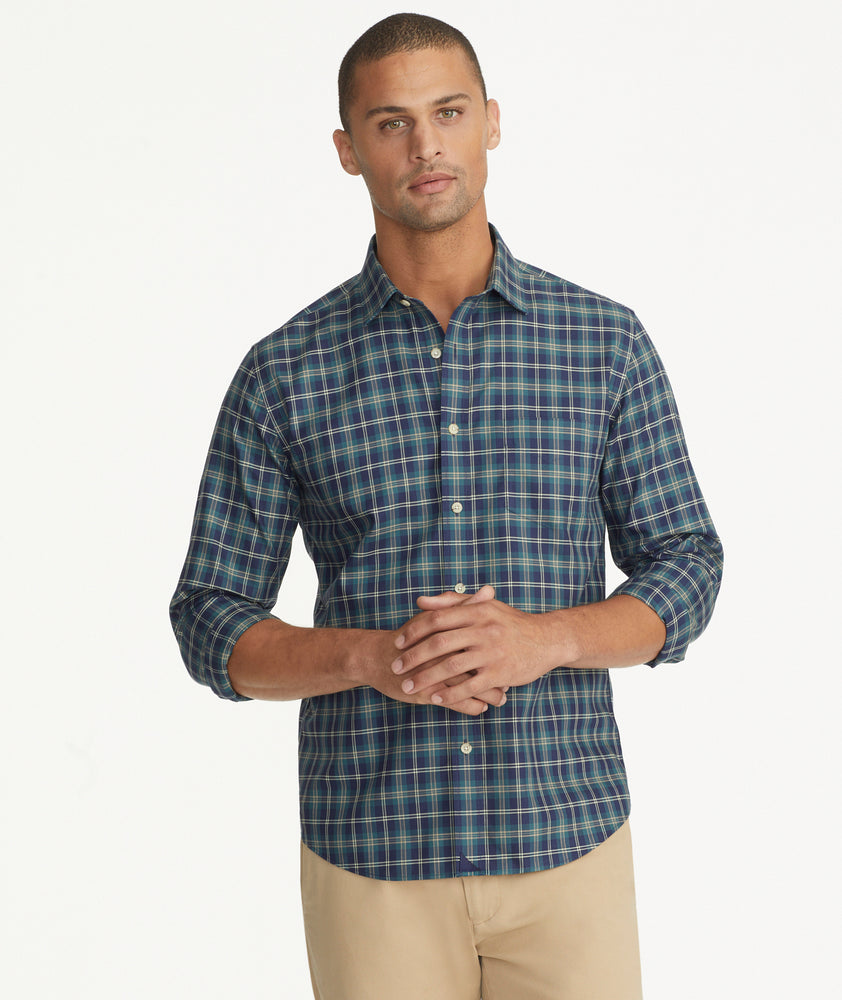 Model is wearing UNTUCKit Wrinkle-Free Harwin Shirt in Navy & Gold Multi Plaid.