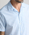 Model is wearing UNTUCKit Performance Short-Sleeve Camp Collar Shirt in blue stripe. 