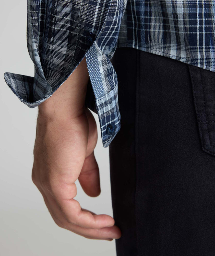 Model is wearing UNTUCKit Wrinkle-Free Hearthstead Shirt in blue and navy check. 