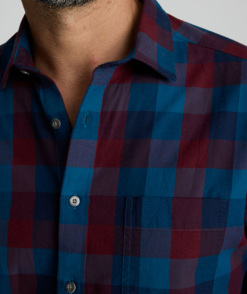 Model is wearing UNTUCKit Heinrich flannel in plaid blue. 