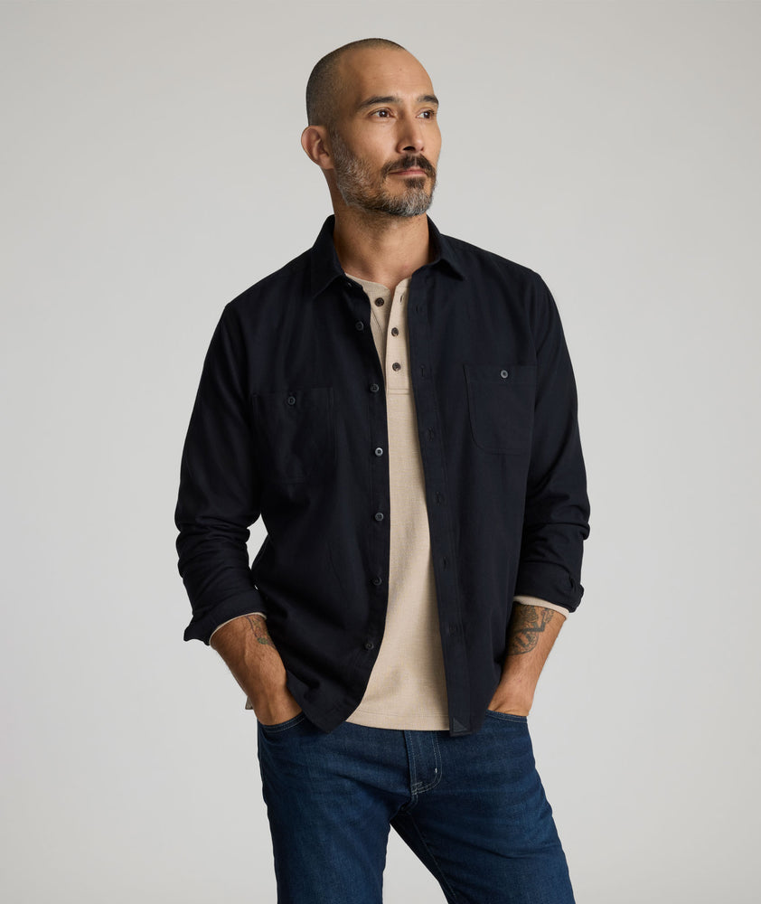 Model is wearing Flannel Hemsworth Shirt in Black Herringbone.