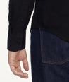 Model is wearing Flannel Hemsworth Shirt in Black Herringbone.