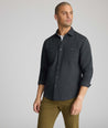 Model is wearing UNTUCKit Flannel Hemsworth Shirt in Deep Gray Herringbone.
