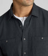 Model is wearing UNTUCKit Flannel Hemsworth Shirt in Deep Gray Herringbone.