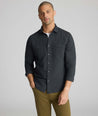 Model is wearing UNTUCKit Flannel Hemsworth Shirt in Deep Gray Herringbone.