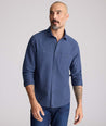 Model is wearing UNTUCKit Flannel Hemsworth Shirt in Indigo.