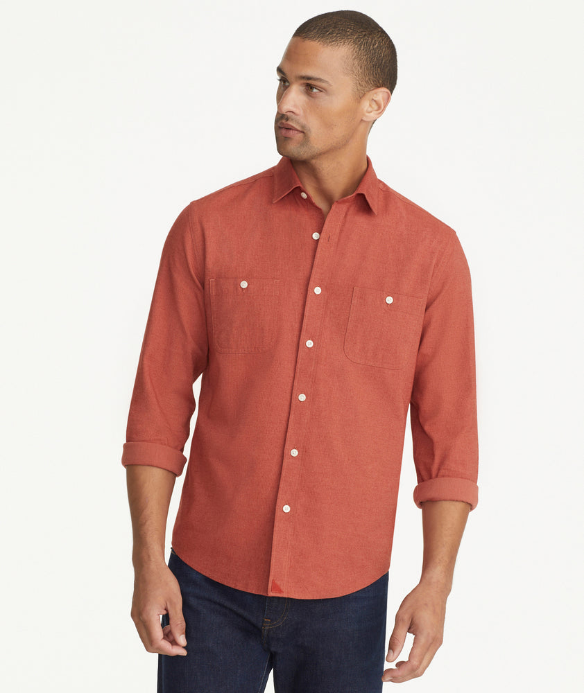 Model is wearing UNTUCKit Flannel Hemswoth Shirt in burnt red.