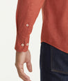 Model is wearing UNTUCKit Flannel Hemswoth Shirt in burnt red.
