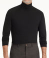 Model is wearing UNTUCKit Hilburn turtleneck in black. 