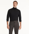 Model is wearing UNTUCKit Hilburn turtleneck in black.