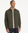Model is wearing UNTUCKit Holderson jacket in forest.