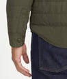 Model is wearing UNTUCKit Holderson jacket in forest.