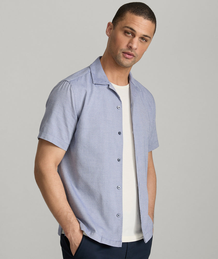 Model is wearing UNTUCKit Hughes in dark blue. 