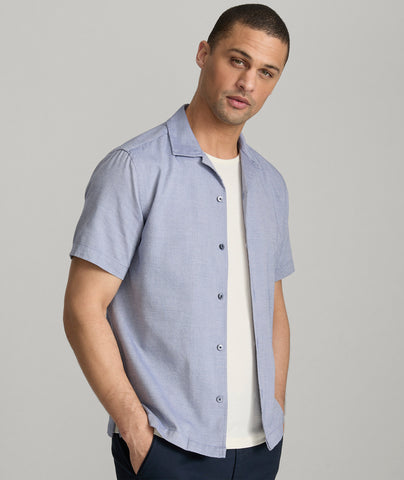 Model is wearing UNTUCKit Hughes in dark blue. 
