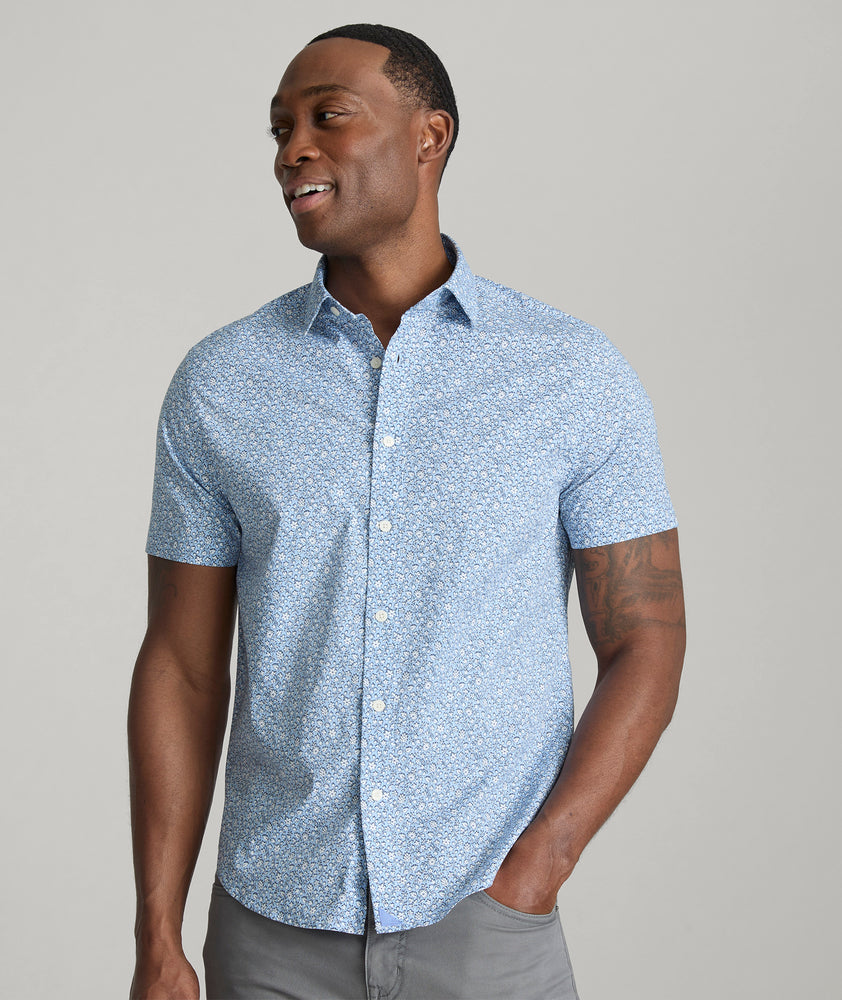 Model is wearing UNTUCKit Hunter short sleeve shirt in blue. 