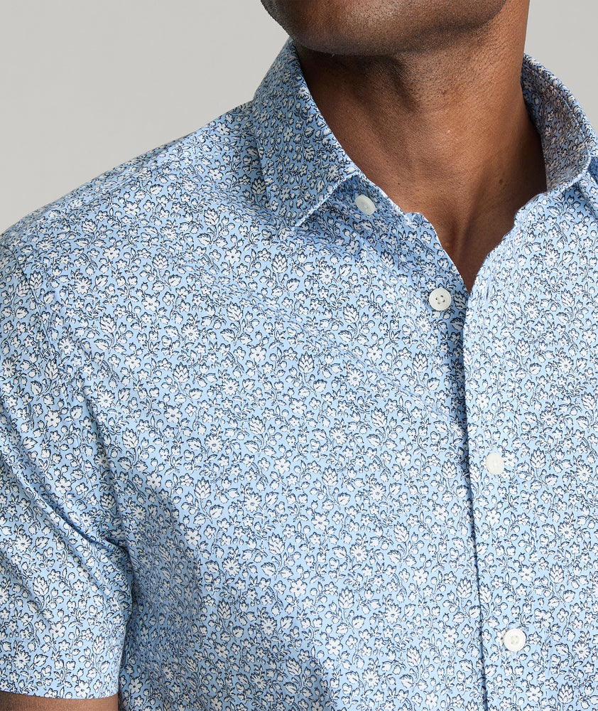 Model is wearing UNTUCKit Hunter short sleeve shirt in blue. 