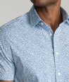 Model is wearing UNTUCKit Hunter short sleeve shirt in blue. 