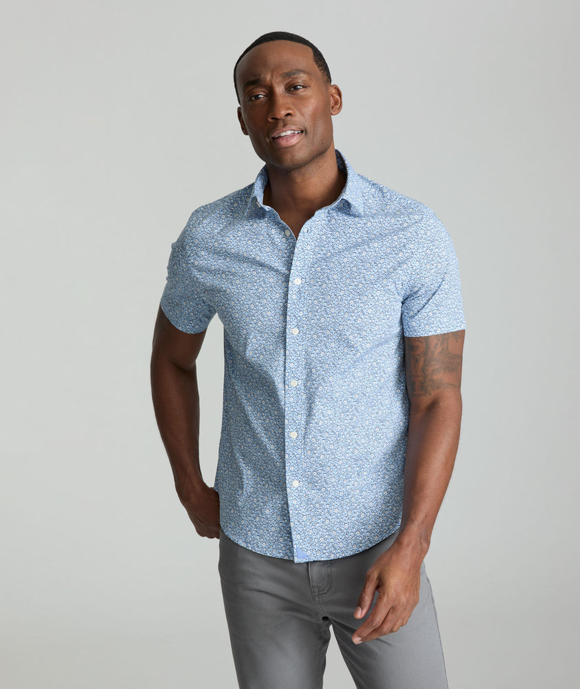 Model is wearing UNTUCKit Hunter short sleeve shirt in blue. 