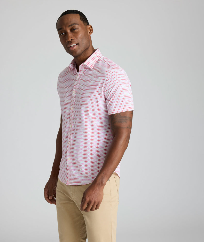 Model is wearing UNTUCKit Ireton short sleeve performance shirt in red. 
