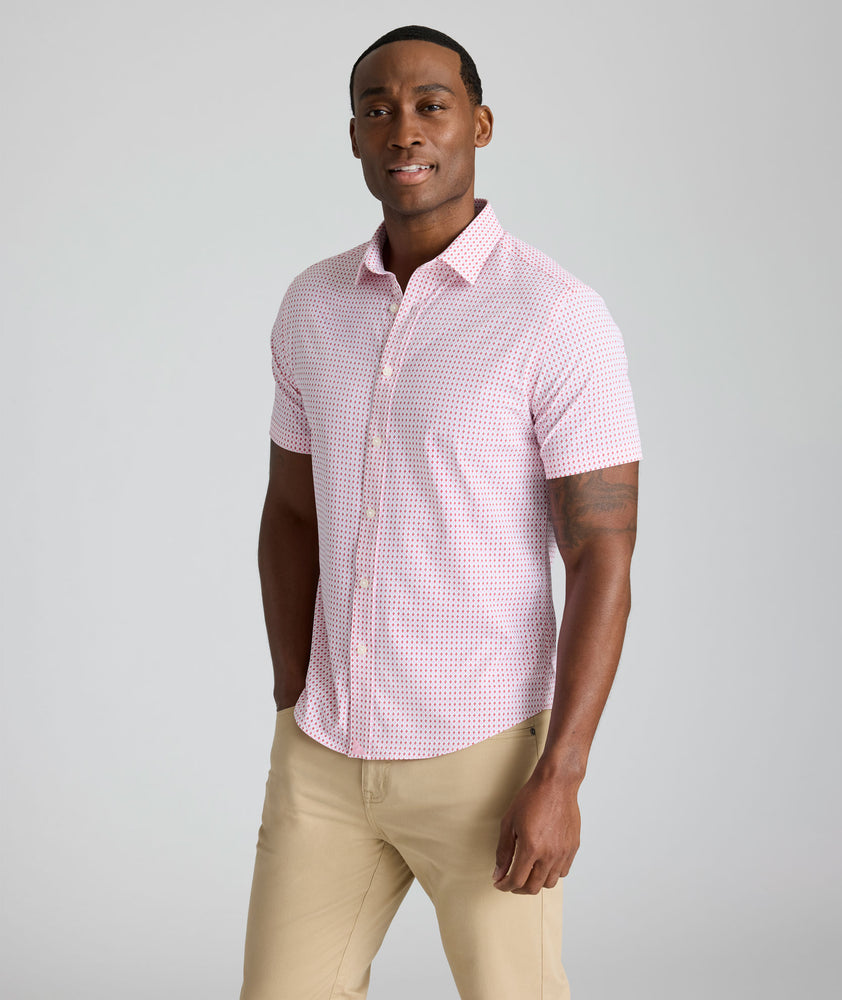 Model is wearing UNTUCKit Ireton short sleeve performance shirt in red. 