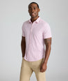 Model is wearing UNTUCKit Ireton short sleeve performance shirt in red. 