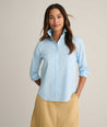 Model is wearing UNTUCKit Isabella wrinkle-free shirt in blue. 