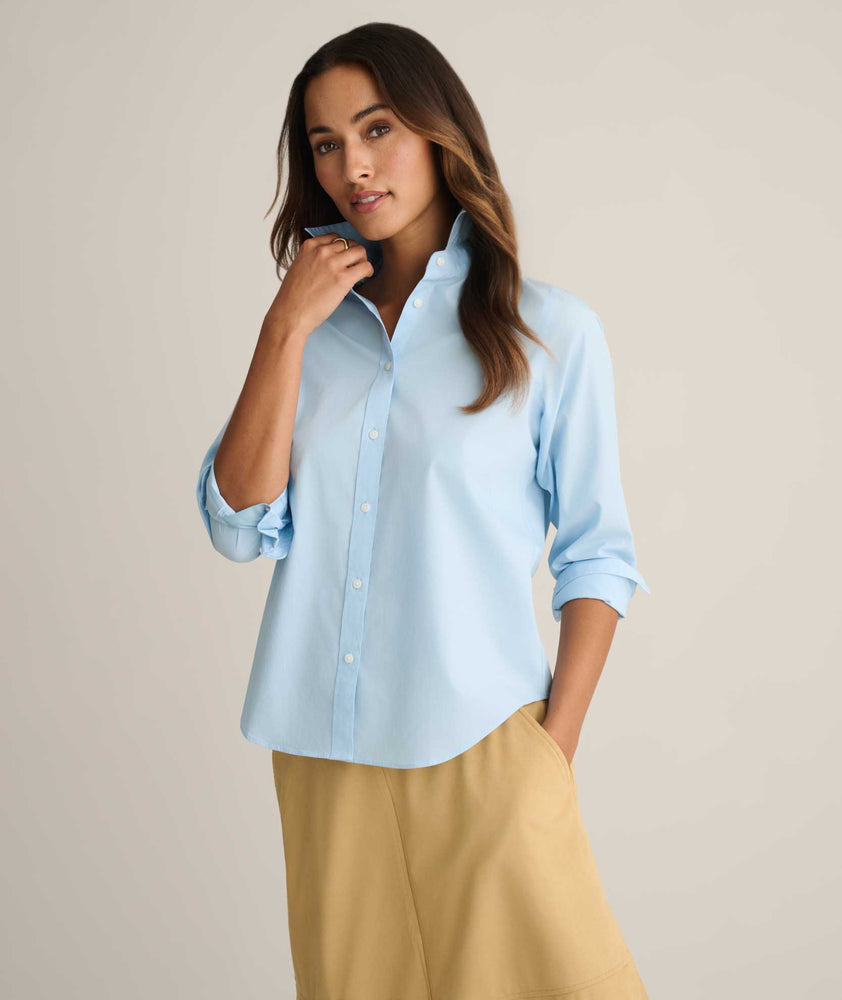 Model is wearing UNTUCKit Isabella wrinkle-free shirt in blue. 