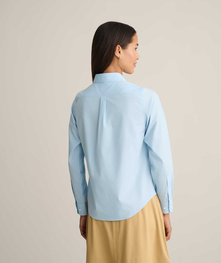 Model is wearing UNTUCKit Isabella wrinkle-free shirt in blue. 