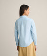 Model is wearing UNTUCKit Isabella wrinkle-free shirt in blue. 