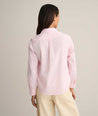 Model is wearing UNTUCKit Isabella shirt in pink. 