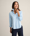 Model is wearing UNTUCKit Isabella shirt in blue and pink stripe. 