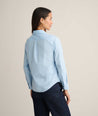 Model is wearing UNTUCKit Isabella shirt in blue and pink stripe. 