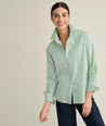 Model is wearing UNTUCKit Isabella shirt in green stripe. 