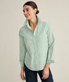 Model is wearing UNTUCKit Isabella shirt in green stripe. 