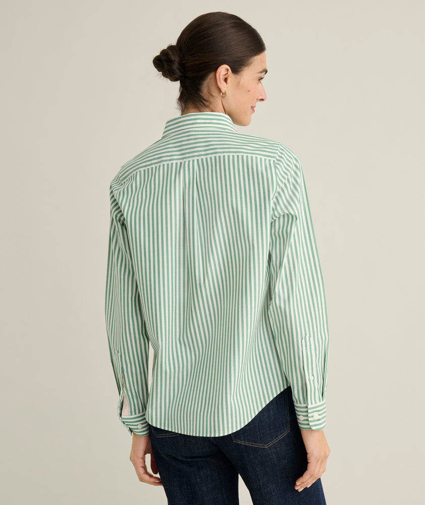 Model is wearing UNTUCKit Isabella shirt in green stripe. 